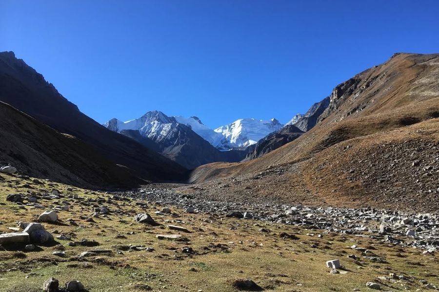 Barren mountain valley in Upper Dolpo with snow-capped peaks